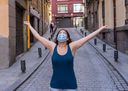 Young woman wearing surgical mask on face in public spaces. Coronavirus spreading protection mask...