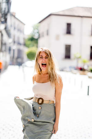 Outdoors close up portrait of young attractive woman with beautiful blonde hair and sensual smile. Female model posing with natural beauty and light. Real People, beauty care, fashion and lifestyle.の写真素材