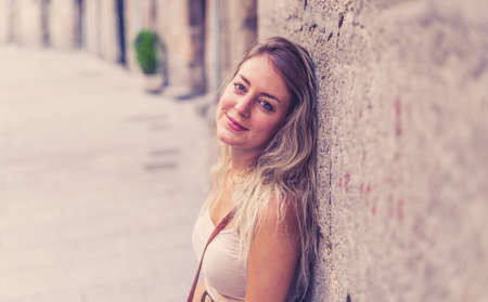 Outdoors close up portrait of young attractive woman with beautiful blonde hair and sensual smile. Female model posing with natural beauty and light. Real People, beauty care, fashion and lifestyle.の写真素材
