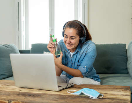 Happy successful woman on laptop working from home. Freelancer or employee in video conference...