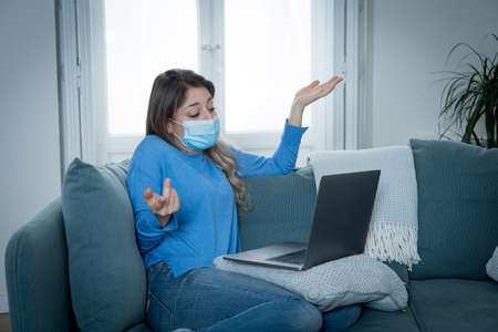 Woman on laptop talking to online doctor in virtual medical consultation while in quarantine at...