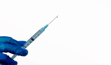 Doctor, nurse, scientist hand in blue gloves holding flu, measles, coronavirus, covid-19 vaccine disease preparing for child, baby, adult, man and woman vaccination shot, medicine and drug concept.の写真素材