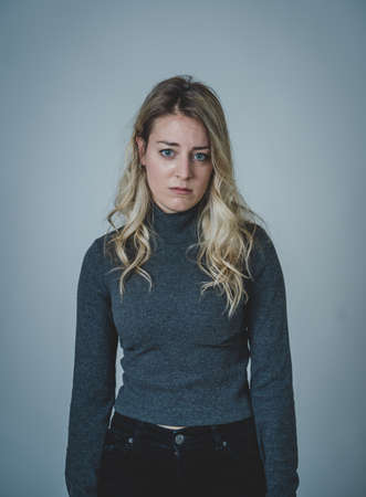 Portrait of young attractive caucasian woman suffering from depression, stress and anxiety. Sad and...