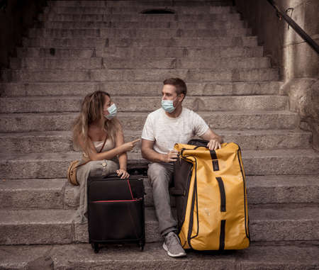 Unhappy tourist couple not able to travel abroad due to virus Travel restrictions.の写真素材