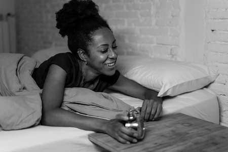 Lifestyle black and white portrait of an attractive young african american female feeling happy secure and comfortable at home. In people, happiness and positive emotions. concept.の写真素材