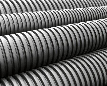 Stack of black spiral storm sewage drain pipesの写真素材