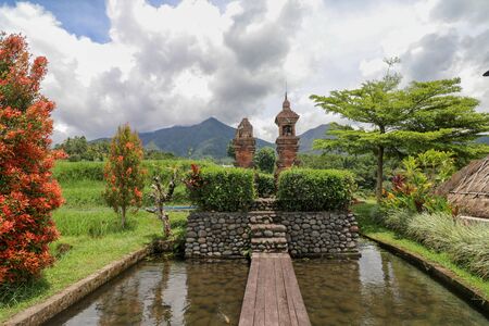 Scenic view of small water Hindu Temples on the beautiful Indonesian Island of Bali. Square toned image.の写真素材
