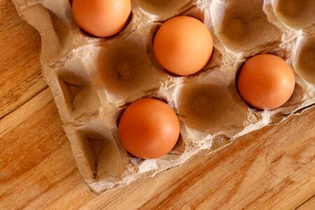 Thirty brown chicken eggs in a cardboard tray packaging. Raw fresh hen eggs in a carton box. Egg...