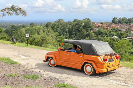 Jatiluwih, Bali, Indonesia: March 30, 2020. An orange volkswagen Thing 181 with black canvas roof...