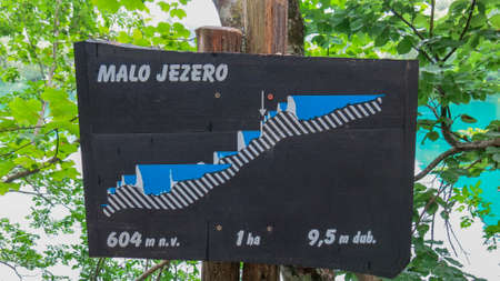 Plitvice Lakes, Croatia, July 3, 2016. Wodden sign board gives visitors of National Park information about lakes.のeditorial素材