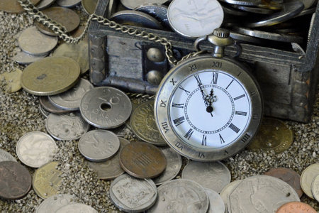 Old pocket watch on the sand with coins. Cryptocurrency dashcoin, cork background, Empty space