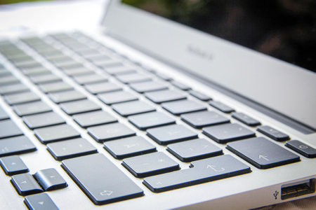 Computer keyboard close-up with empty space. black illuminated laptop keyboard