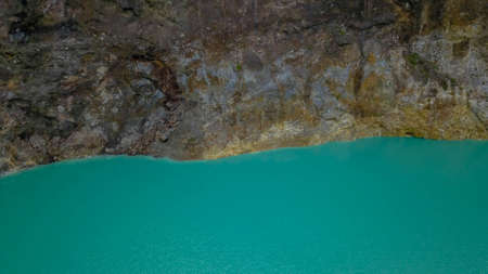 A close up view of the surface of Lake Alapolo and the crater wall. aerial footage of Kelimutu...