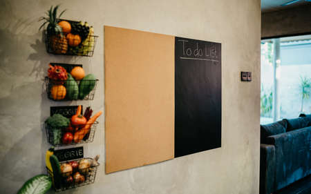 Vintage interior design of kitchen space with table on a shadow gray concrete stylish wall...