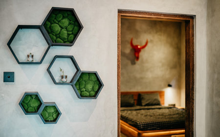 Haxagon shelves with decorative elements on grey color wall. Interior design