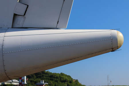 Detail of white airplane tail with blue sky in backgroundの写真素材