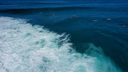 View from above of Big Waves rolling on the blue ocean. Sunny day over the sea in Uluwatu beach Bali.の写真素材