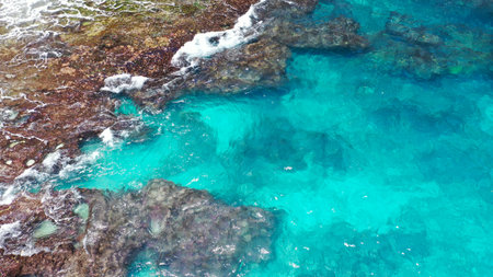 Aerial shot of the turquoise blue water in hole Broken Beach. Famous tourist place on the Nusa Penida island, Indonesiaの写真素材