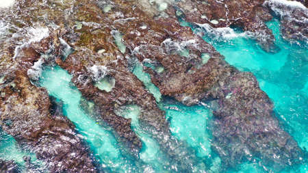 Beautiful rocks in turquoise water. waves rolled on shore stone, broken and hissingの写真素材