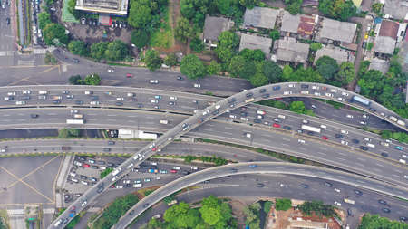 Aerial top down view on massive multi-level interchange on Jakarta city on a sunny summer day with...