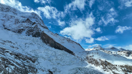 Mauntain glacier panoramic view with blue sky and snow.