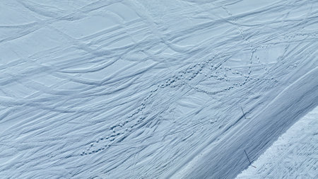 Aerial view of snow covered surface with impressive structure. Snow surface on sunny in top view.