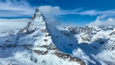 Scenic view of snowcapped Matterhorn mountain peak. Beautiful snow covered white landscape against...