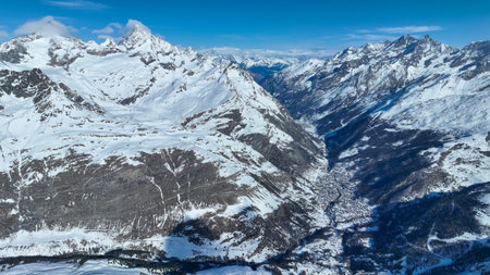 Drone Aerial of the beautiful resort and spa town Zermatt in the swiss alps. The ski and winter season has begun with heavy snow fall in Switzerland, Europeの写真素材