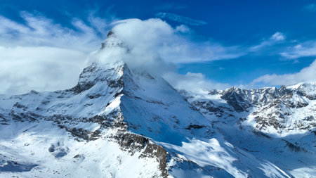 The amazing Matterhorn and surrounding mountains in the Swiss Alps with fantastic cloud formationsの写真素材