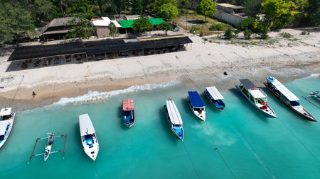 Boats on the water surface from top view. Turquoise water background from top view. Summer seascape from air. Gili Meno island, Indonesia. Travel imageの写真素材