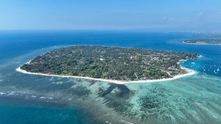 Drone aerial view of Gili islands, Lombok, Indonesia. Daytime panorama of Gili Trawangan, Gili Meno and Gili Air. Clear blue water, coral reefs and white sandy beaches. Tropical paradise from aboveの写真素材