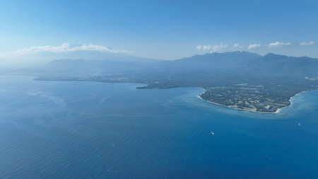 Discover the stunning shores of Lombok island from above. Panoramic shot captures the islands pristine beaches, turquoise waters and dramatic mountain backdrop, showcasing untouched charm of Lombokの写真素材
