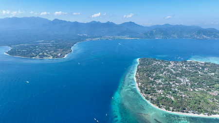 A short distance from the dramatic mountains of Lombok. This stunning panorama highlights the unique charm and natural splendor of both Gili Air and the island of Lombokの写真素材