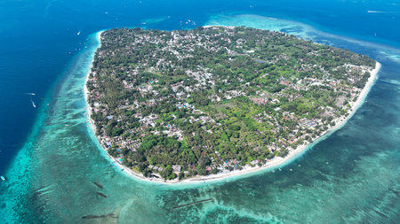 Drone aerial view of Gili islands, Lombok, Indonesia. Daytime panorama of Gili Trawangan, Gili Meno and Gili Air. Clear blue water, coral reefs and white sandy beaches. Tropical paradise from aboveの写真素材
