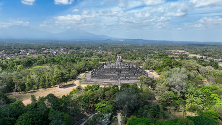 Stunning drone shot of Borobudur Temple and Mount Merapi in the background in Indonesiaの写真素材
