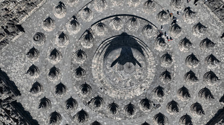 Marvel at the perfect alignment of Borobudur stupas in this stunning top-down shot, capturing the...