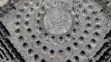 Marvel at the mesmerizing symmetry of Borobudur, the worlds largest Buddhist temple, captured from above. The concentric circles of stupas create a hypnotic geometric patternの写真素材