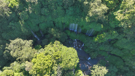 Aerial view of Benang Kelambu waterfall in the tropical forest in Lombok, Indonesiaの写真素材