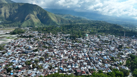 The village of Sembalun nestles at the foot of rolling hills, its rooftops blending into the lush scenery an authentic glimpse of rural life in Lombokの写真素材