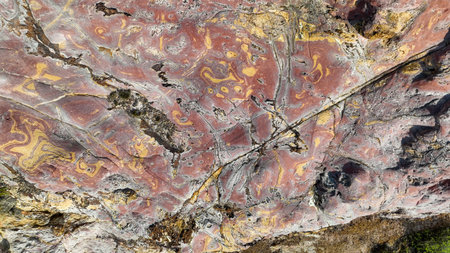Pink and gold swirls cover rock