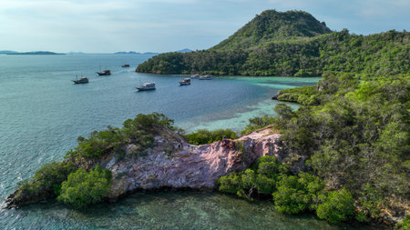 Adventurers pose on vibrant red rock formations as mangroves and clear shallows reveal the hidden...