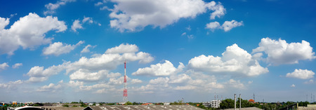 Panorama of blue sky and clouds with cellular communications towerの写真素材