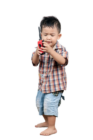 cute 2 year old, asian children playing walkie talkie radio, isolated on whiteの写真素材