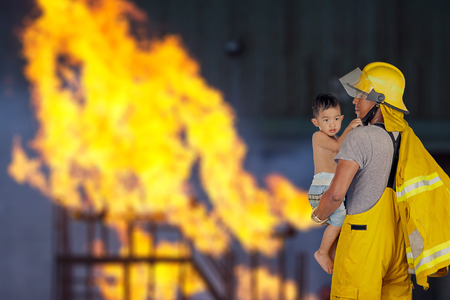 firefighter, fireman rescued the child from the fireの写真素材