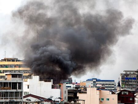 Fire burning and black smoke over the commercial building.の写真素材
