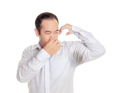 Asian man wearing shirt disgusting with bad smell of his wet armpit., Something stinks, negative human emotions, facial expressions, feeling reaction., Arm raised with transpiration stain underarm.の写真素材