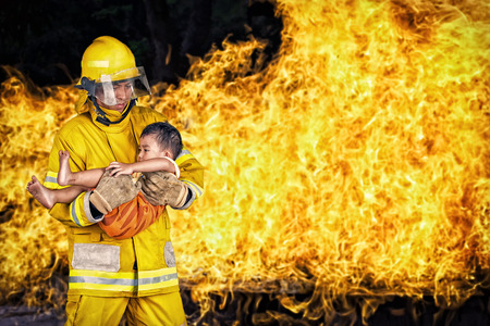 firefighter., rescue fireman save a child from fire incident.の写真素材