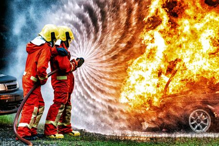 firefighter training., fireman using water and extinguisher to fighting with fire flame in accident...