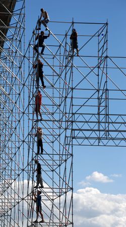 Builders on framework of high-floor modern construction. Metallic framework of the stageの写真素材
