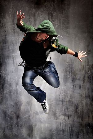 coll looking dancer posing on a grunge grey wall coll looking dancer posing on a grunge grey wall